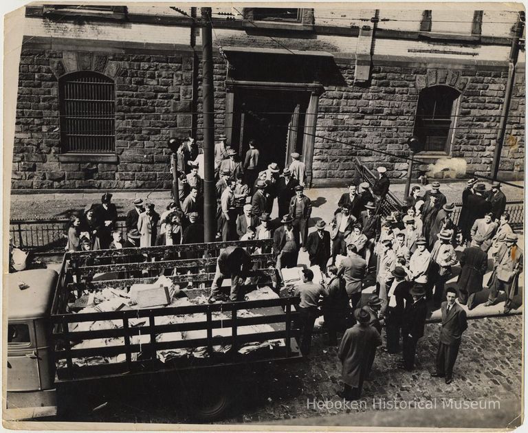 B+W photo of men moving City of Hoboken records on Newark St. side of City Hall, ca. June, 1947. picture number 1