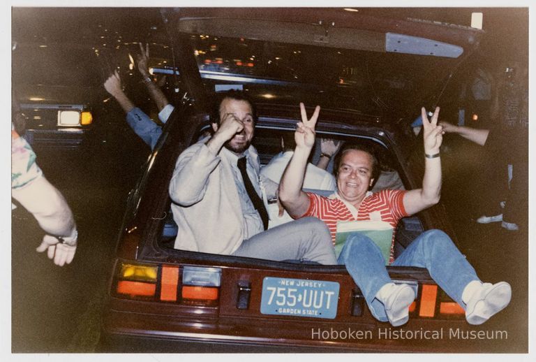 Color photo of two supporters of mayoral candidate Tom Vezzetti sitting in the back of a car on election night, Hoboken, [June 11, 1985]. picture number 1