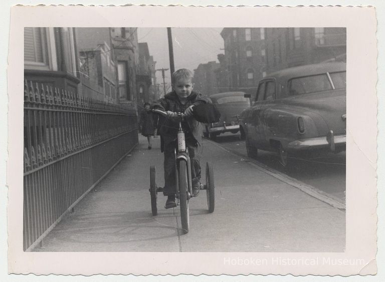 B+W photo of George Miller on a tricycle near Twelfth St. & Park Ave., Hoboken, n.d., ca. early 1950s. picture number 1