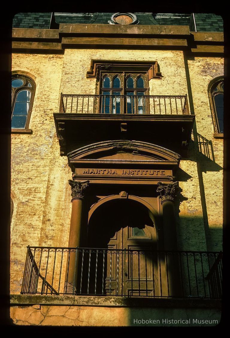 Color slide of close-up view of portico, railings, pediment and frieze reading 