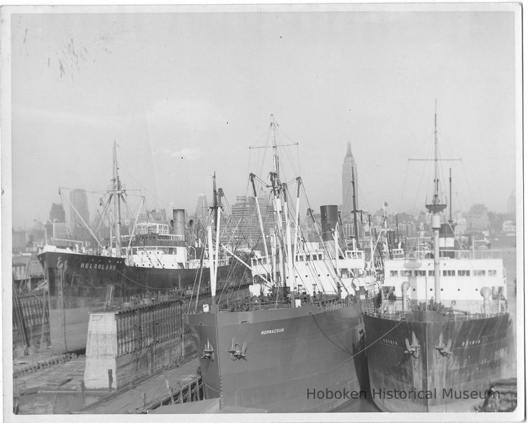 B+W photo of the S.S. Helgoland in dry dock; 2 ships berthed south of dry dock, Hoboken, no date, ca. 1940. picture number 1