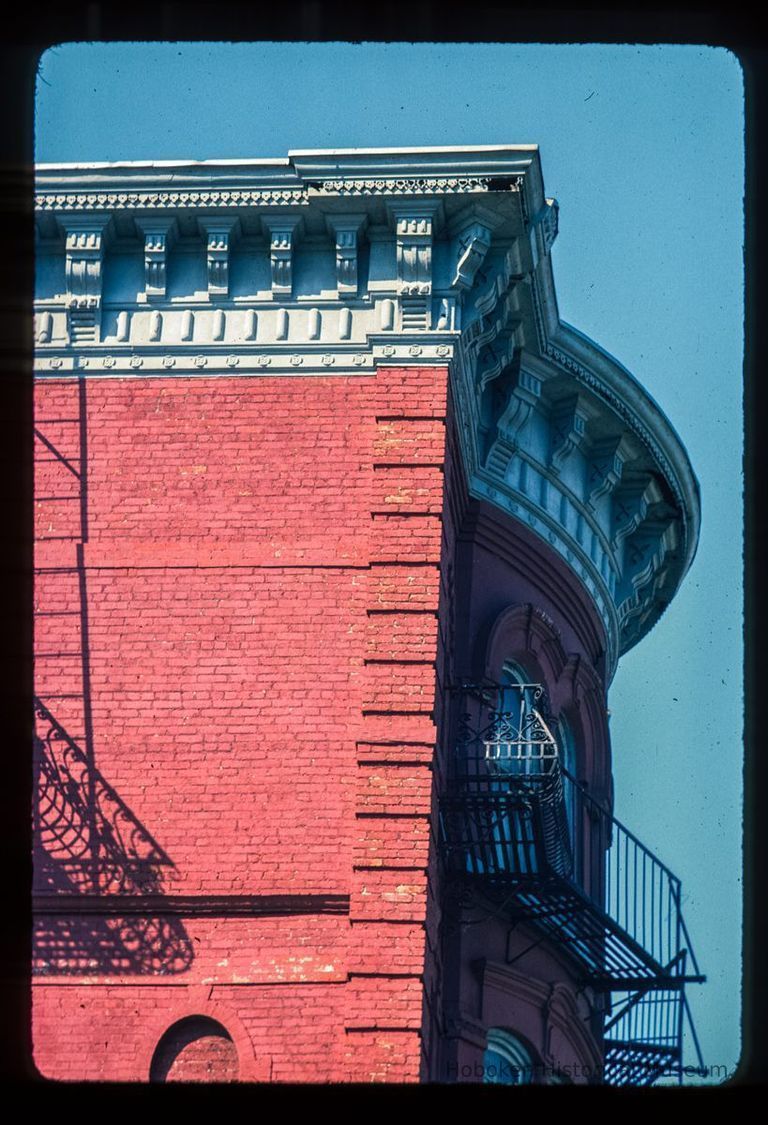 Color slide of detail view of cornice, brackets, quoins, and fire escape at 76 River on the NW corner of River and Hudson Place picture number 1