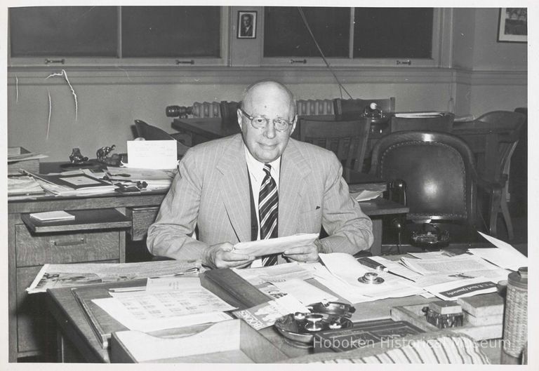 B+W photo of R. Neumann & Co. executive seated at desk, Hoboken, no date, ca. 1950-60. picture number 1