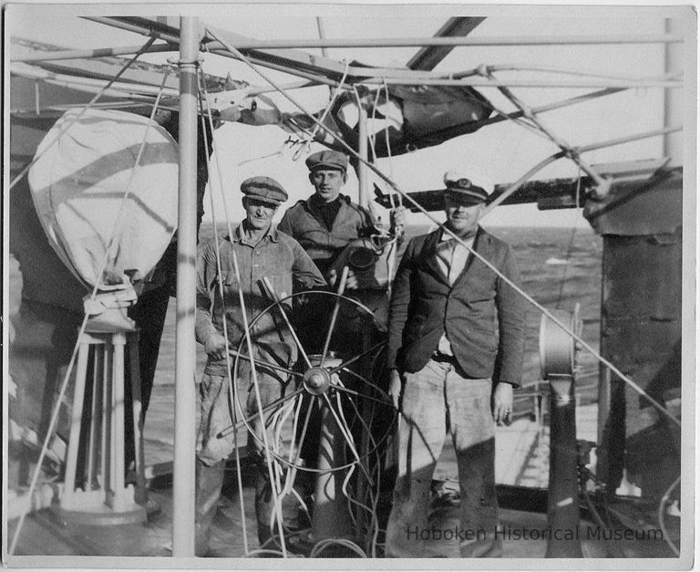 B+W photo of three men at ship's wheel on unidentified vessel, no place, no date, ca. 1940. picture number 1