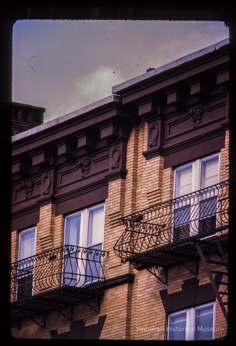 Color slide of detail view of cornices, friezes, dentils and fire escapes on two buildings on the E side of Willow between 12th and 13th picture number 1