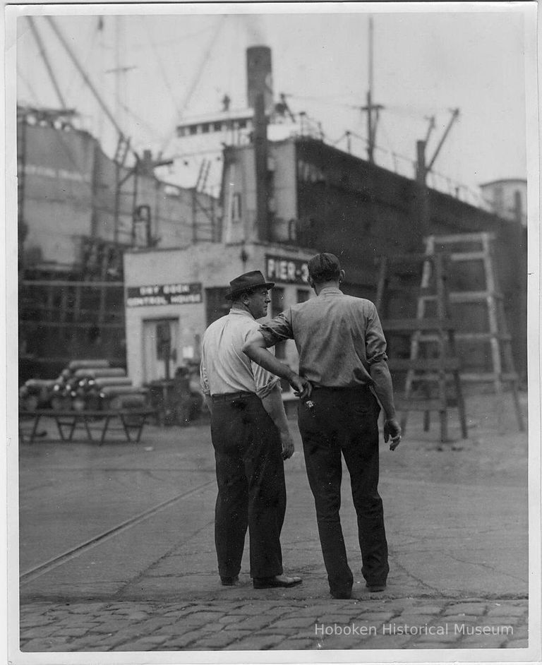 B+W photo of two men, probably supervisors, near head of Pier 3, at Bethlehem Steel Shipyard, Hoboken Division, no date, ca. 1940. picture number 1