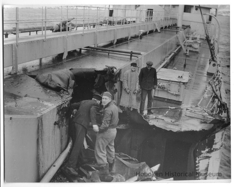 B+W photo of workers inspecting damage on main deck of unknown ship, Hoboken, no date, ca. 1940. picture number 1