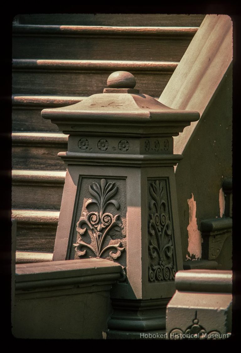 Color slide of detail view of stoop balustrade and newel at one of the buildings between 632 and 638 Hudson on the SW corner with 7th picture number 1