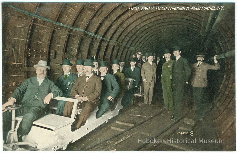 Digital image of Hudson & Manhattan R.R. postcard titled: First party to go through the McAdoo Tunnel, N.Y. no date, ca. 1908. picture number 1