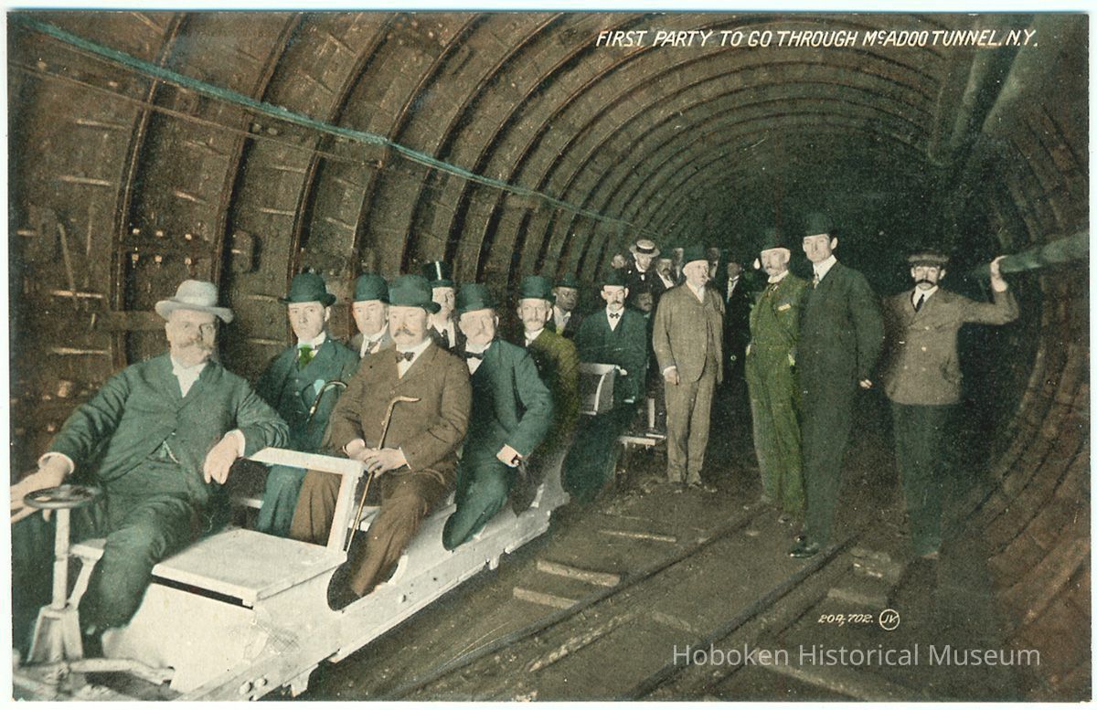 Digital image of Hudson & Manhattan R.R. postcard titled: First party to go through the McAdoo Tunnel, N.Y. no date, ca. 1908. picture number 1