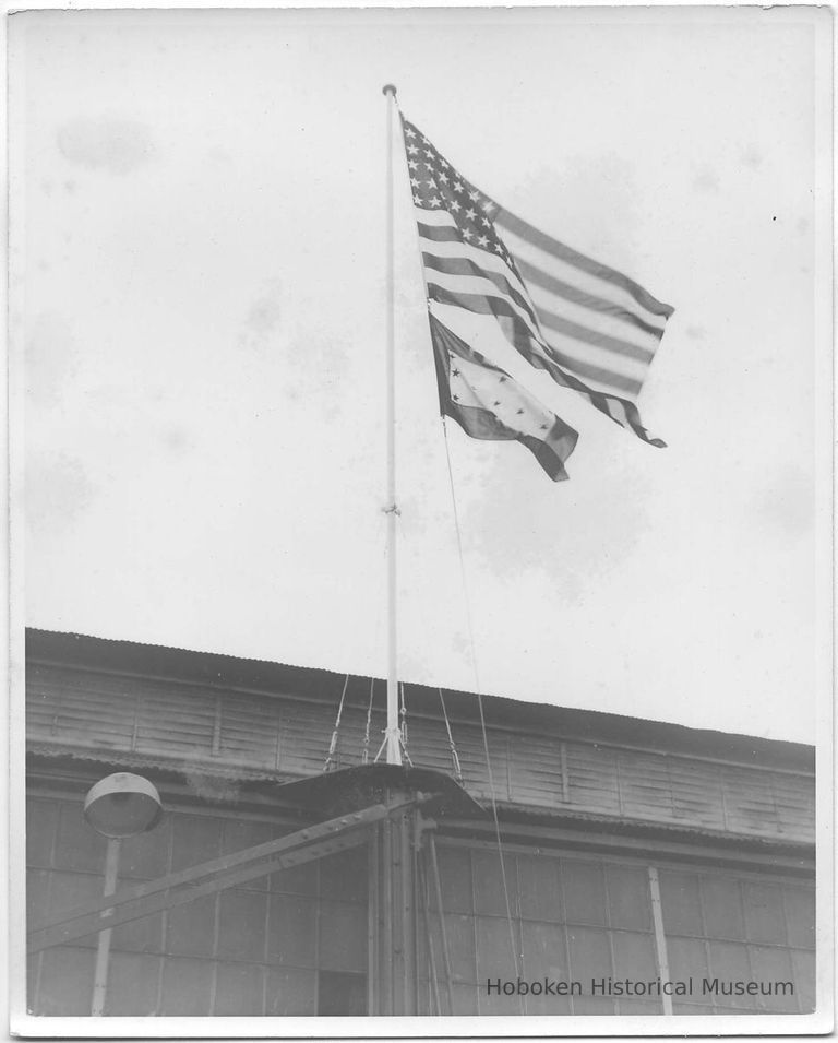 B+W photo of a 48-star American flag with a rectangular pennant below it, Hoboken, no date, ca. 1941-1945. picture number 1