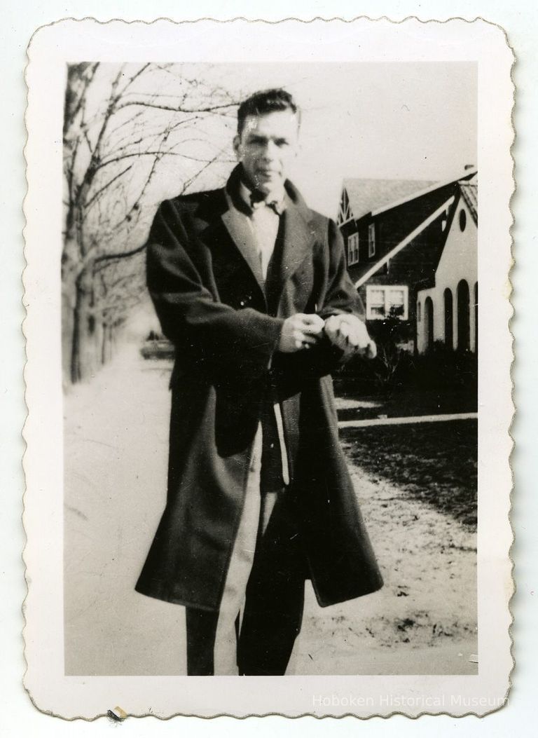 1: Sinatra walking on street in a neighborhood