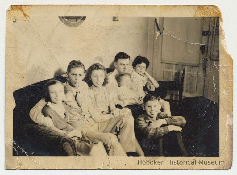 B+W group photo posed on sofa inside Smith home, 15 Willow Terrace, Hoboken, n.d., ca. late 1940s. picture number 1