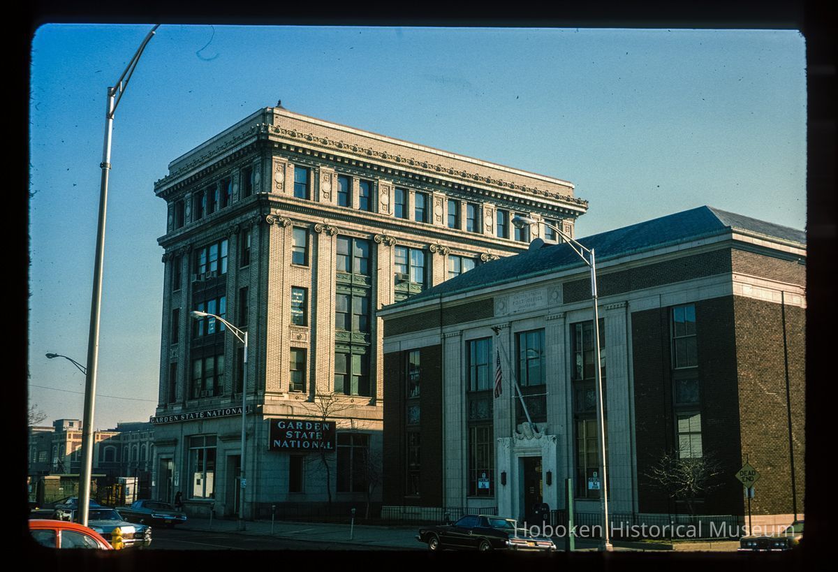 Color slide of eye-level view of the façades of the U.S. Post Office building on the right at 89 River and the Steneck Building/Seaboard Building on the left at 95 River occupied by the Garden State National Bank between Newark and 1st picture number 1