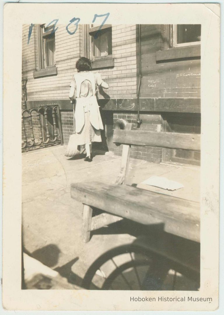 B+W photo of a Mrs. McNamara on street in front of building, location not known, Hoboken, September, 1937. picture number 1