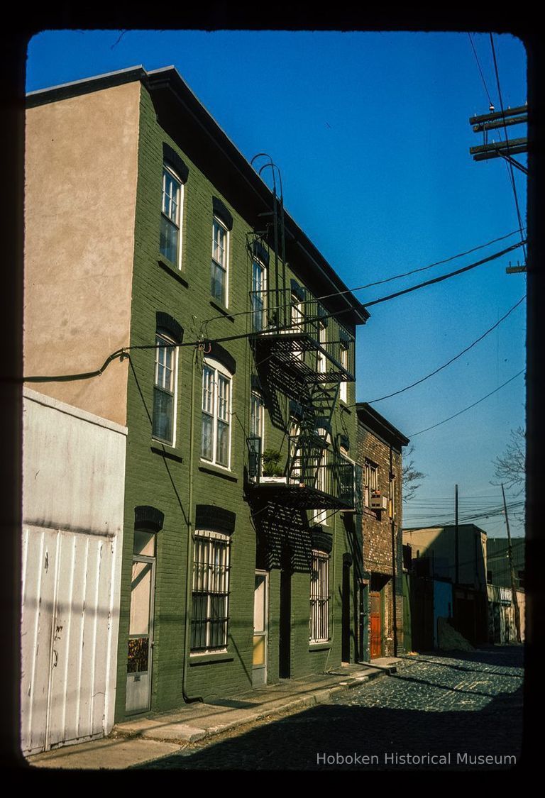 Color slide of eye-level view row house façades with fire escape on Court between 4th & 5th picture number 1