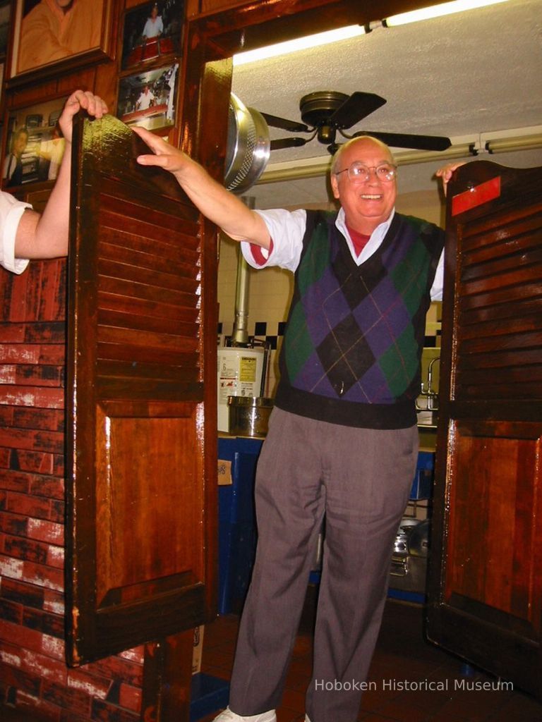 Digital copy of color photo of one of the owners of Piccolo's Clam Bar talking to food tour members there, 92 Clinton St., Hoboken, Oct. 18, 2003. picture number 1