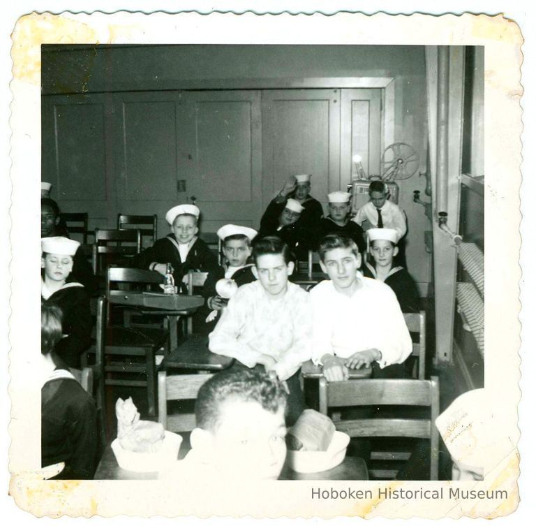 B+W photo of a classroom interior of boys, some in sailors' uniforms, at a meeting, Hoboken, no date, ca. 1940-1945. picture number 1