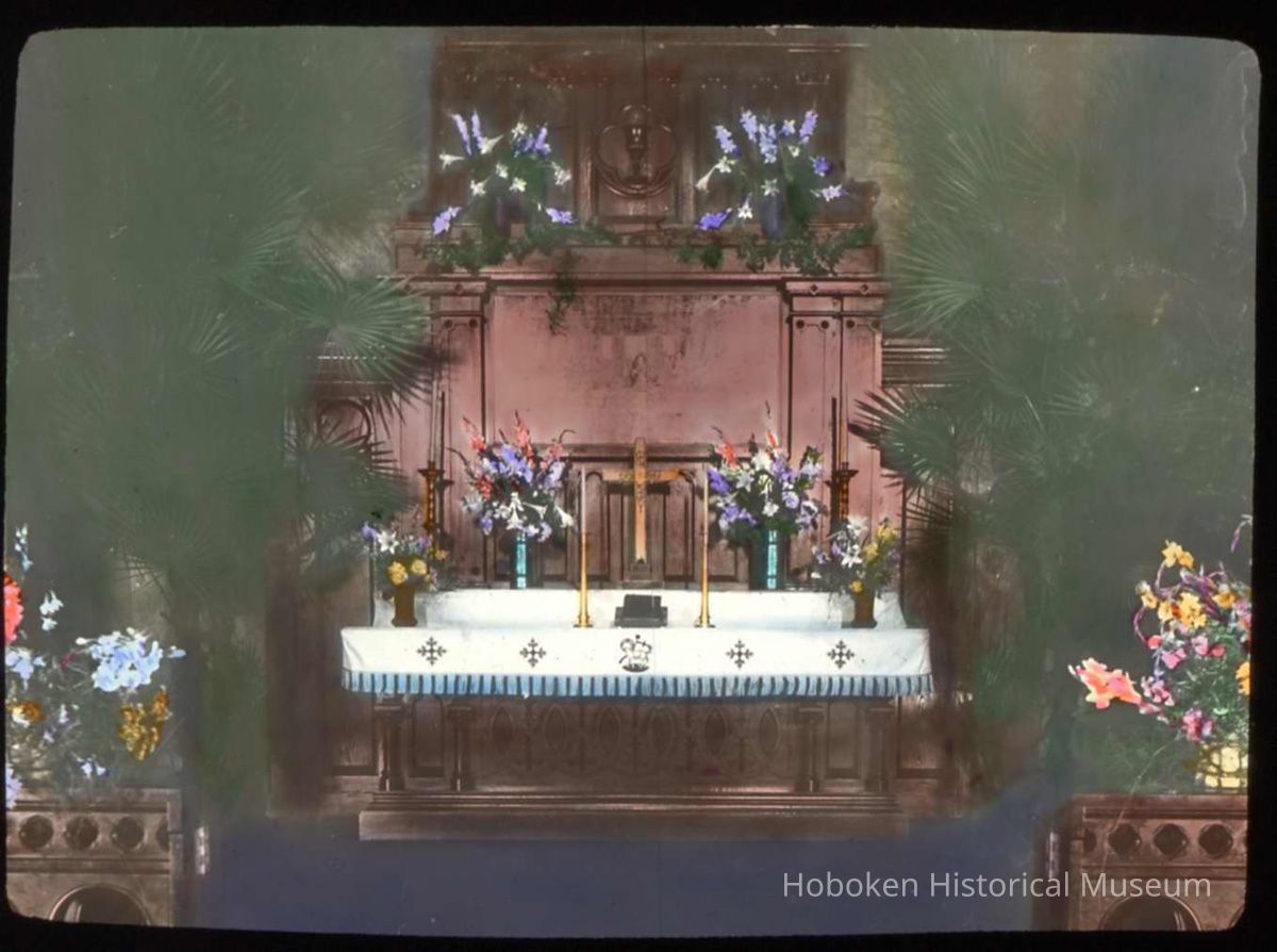 Lantern slide, color, of a church interior with floral decorations, used for promotional display in Hoboken, no date, ca. 1920. picture number 1