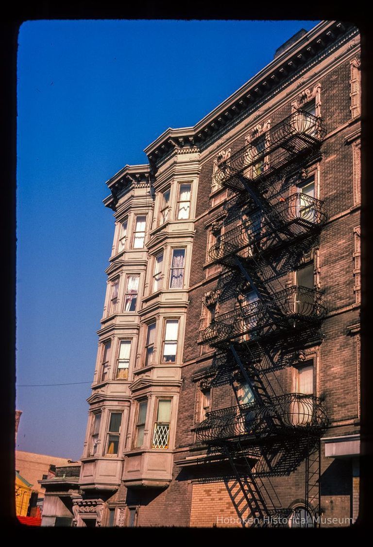 Color slide of detail view of row house façades, cornices and fire escape on buildings at Washington and 3rd picture number 1