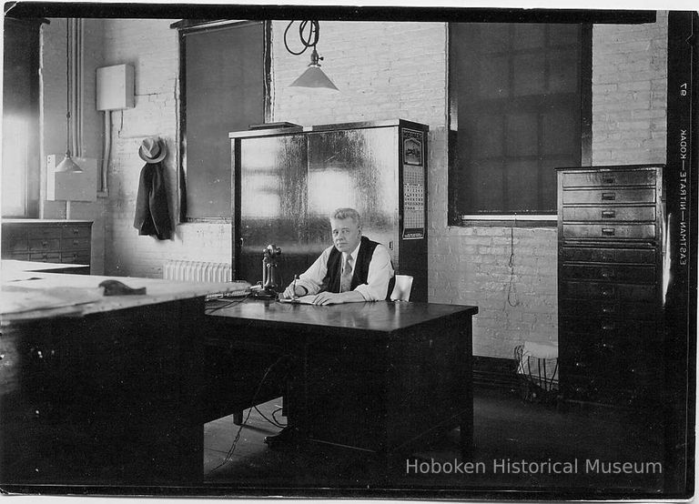 B+W photo of supervisor sitting at desk in drafting room, United Dry Dock Co., Hoboken, 1931 picture number 1