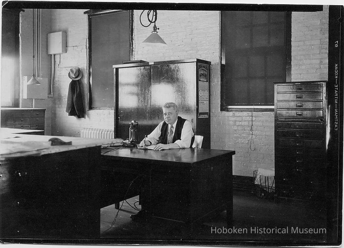 B+W photo of supervisor sitting at desk in drafting room, United Dry Dock Co., Hoboken, 1931 picture number 1