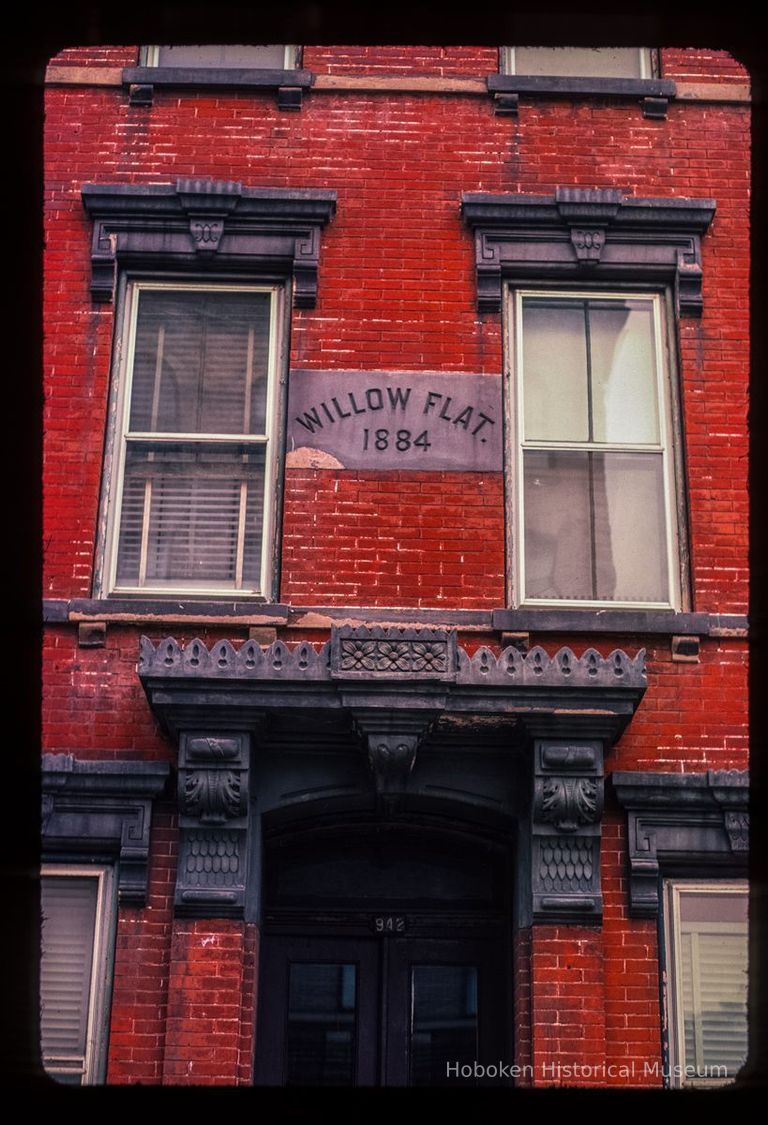 Color slide of close-up view of portico, pediments, brackets and date stone reading 