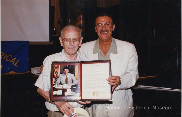 Color photo of Mayor Anthony Russo handing Mayoral Proclamation to George Kirchgessner, Hoboken City Hall, June 27, 1997. picture number 1