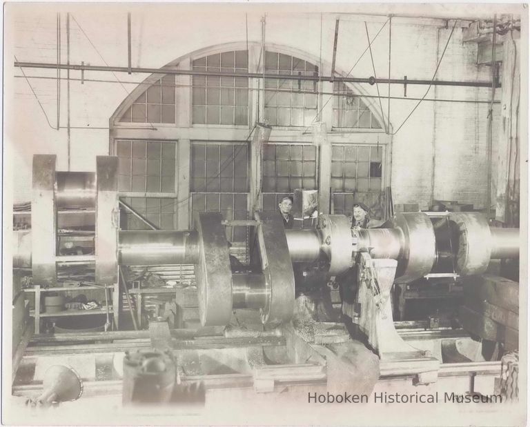 B+W photo of a crank shaft on large lathe with 2 machinists, machine shop, Hoboken, no date, ca. 1935-40. picture number 1