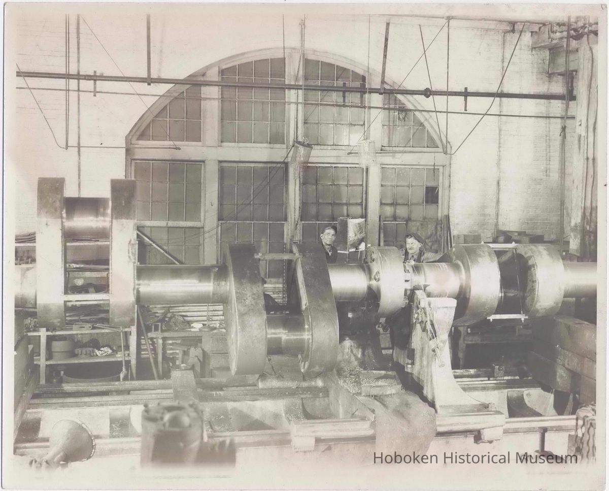 B+W photo of a crank shaft on large lathe with 2 machinists, machine shop, Hoboken, no date, ca. 1935-40. picture number 1
