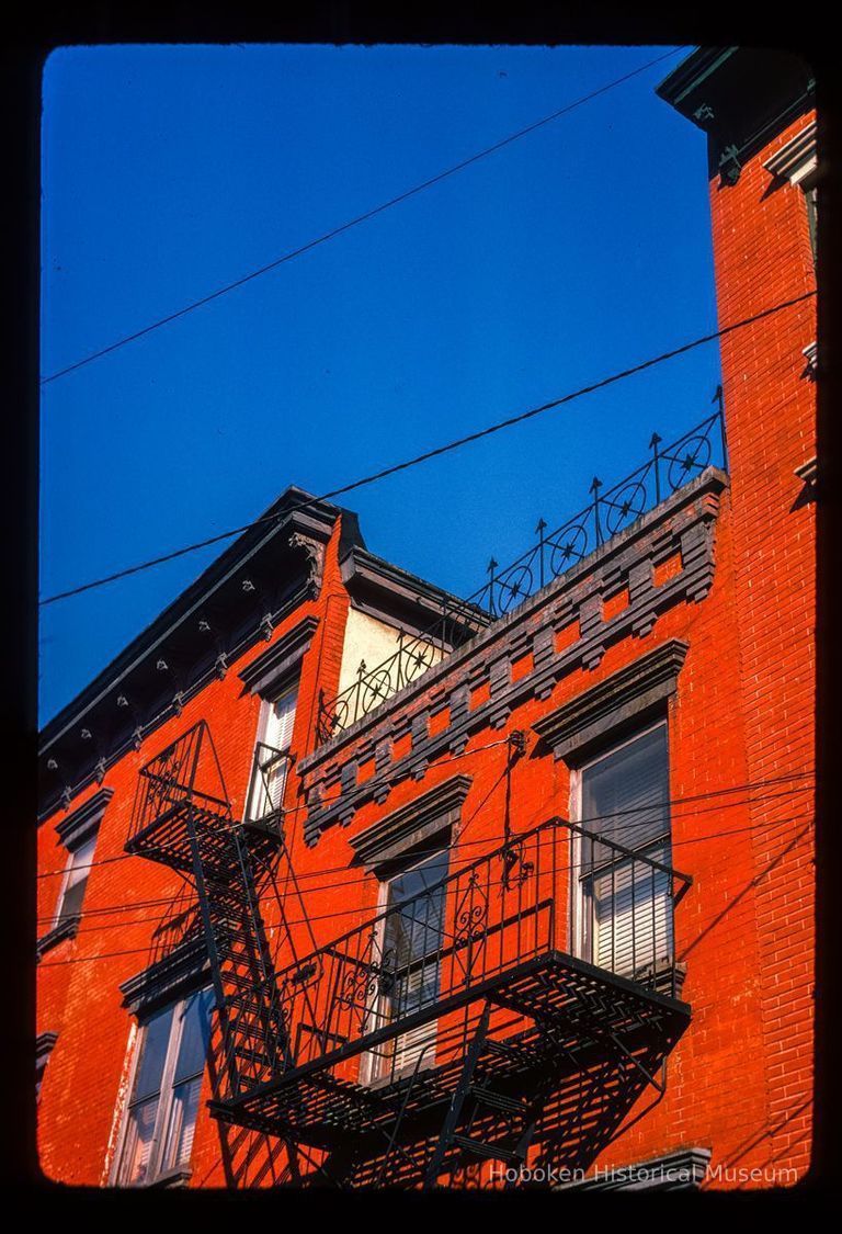 Color slide of detail view of cornice, fire escape and façade of buildings on 10th between Washington and Bloomfield picture number 1