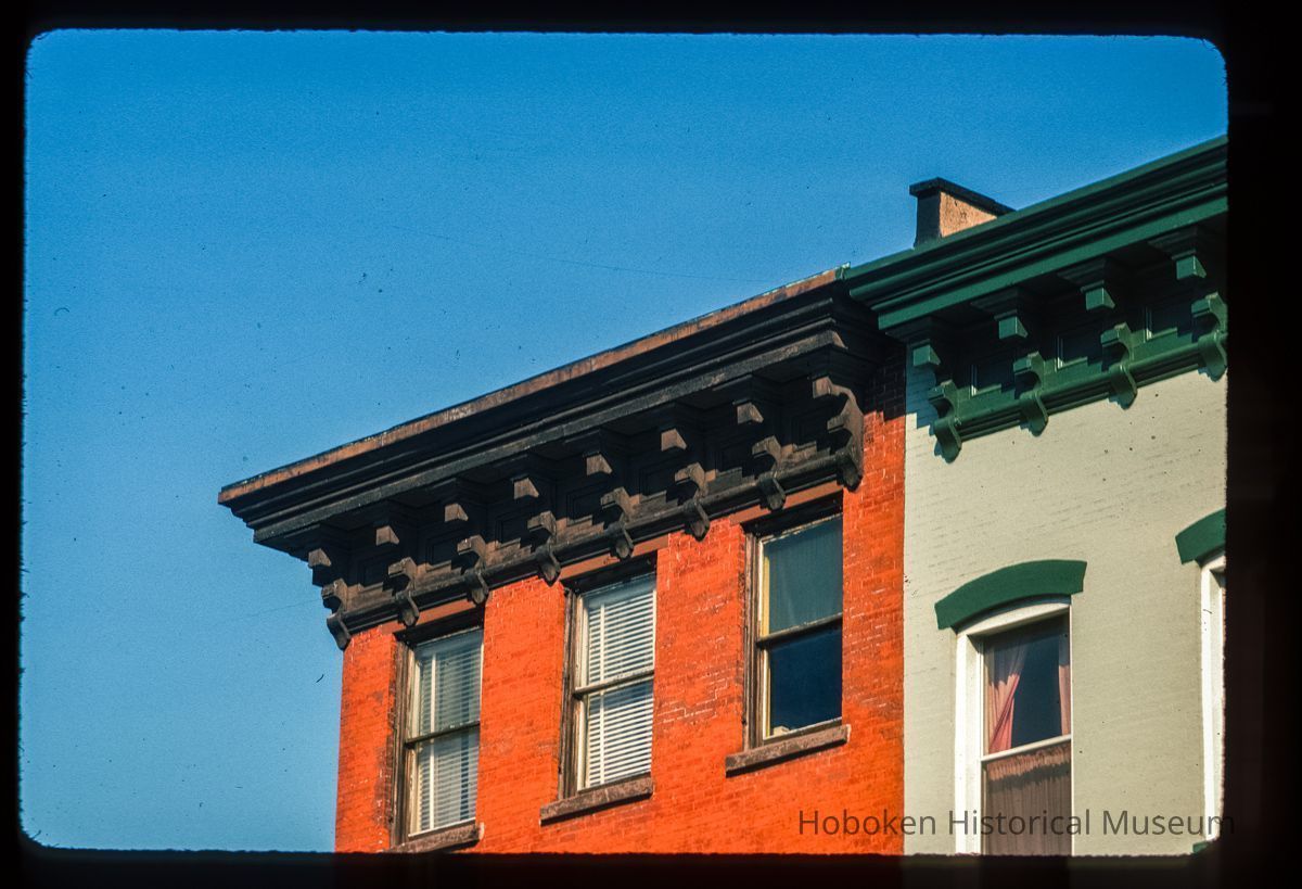 Color slide of close-up view of cornices, brackets, dentils and window heads on two buildings at an unidentified location picture number 1