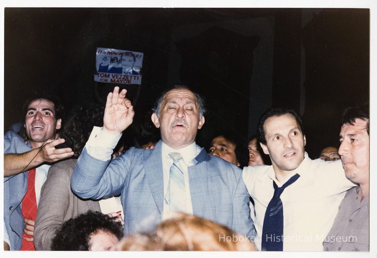 Color photo of mayoral candidate Tom Vezzetti in front of City Hall with supporters on election night, Hoboken, [June 11, 1985]. picture number 1