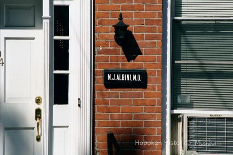 Color photo of house front and sign for M.J. Albini, 204 Fifth St., Hoboken, Sept., 1-5, 2001. picture number 1