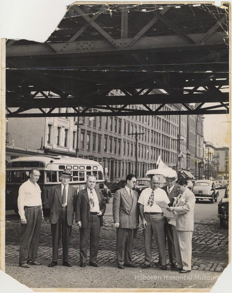 B+W photo of men under streetcar elevated structure on Observer Highway at Washington St., Hoboken, circa 1947-1950. picture number 1