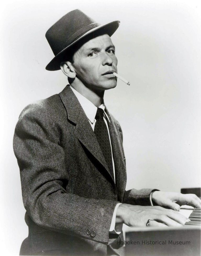 Black-and-white photo, movie still, of Frank Sinatra at piano from film 