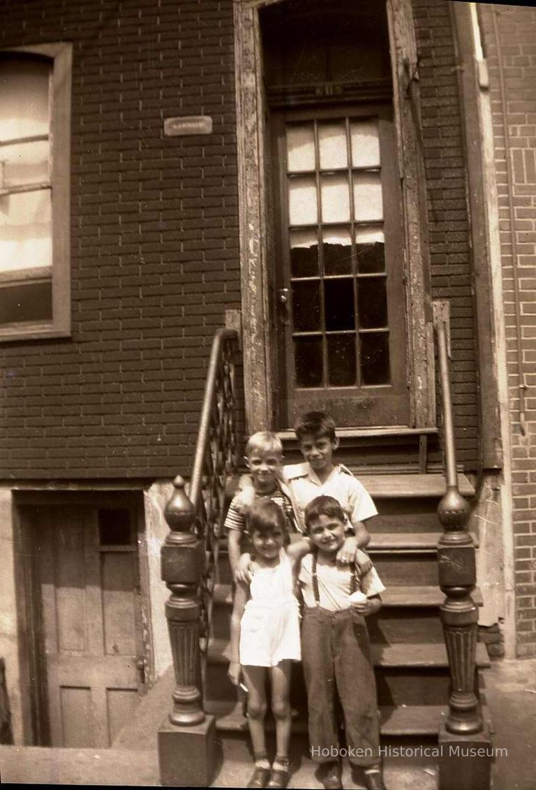 Black-and-white negative of three boys and a girl posed on a front stoop, Hoboken, no date, ca. 1930-40. picture number 1