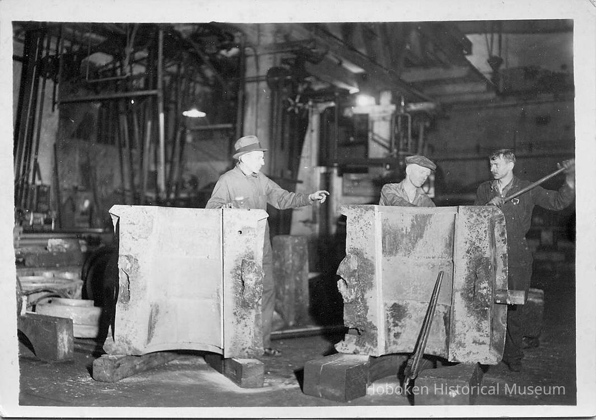 B+W photo of propeller hub halves showing interior with 2 workers & a supervisor, United Dry Dock, Hoboken, no date, ca. 1937. picture number 1