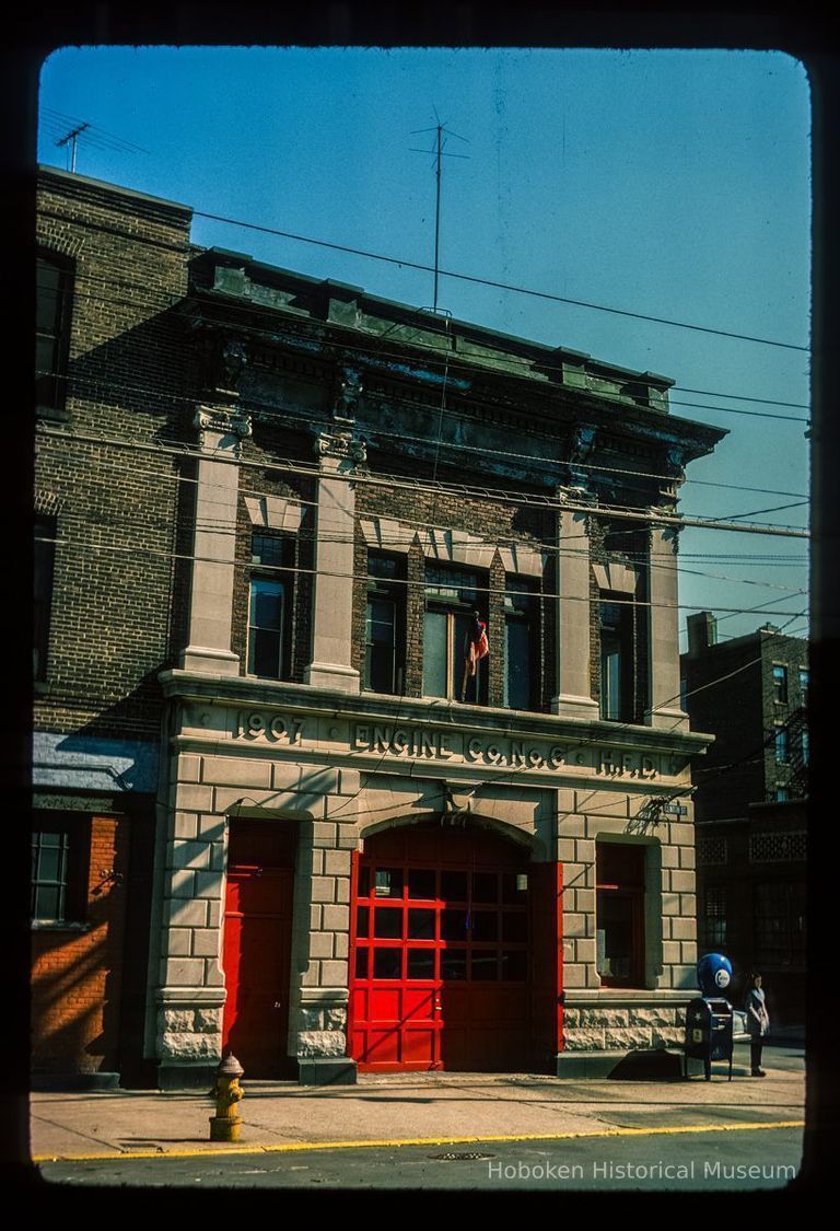 Color slide of eye-level view of the Hoboken Fire Department Engine Company No. 6 fire station façade and frieze reading 