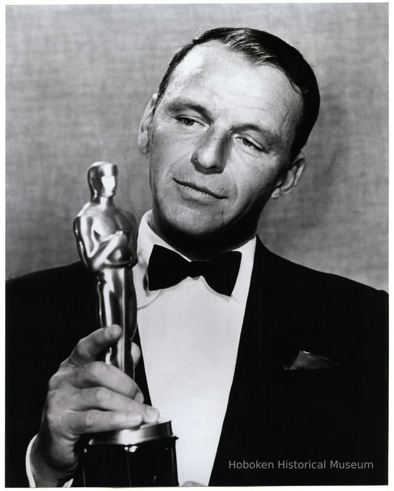 Frank Sinatra holding his Oscar