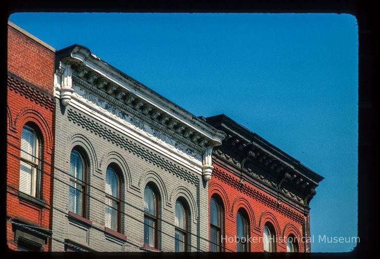 Color slide of close-up view of cornices, brackets, friezes and brick semicircular arches at 510 and 514 Observer Highway on the NE corner with Madison picture number 1