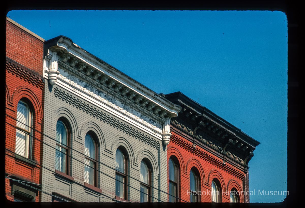 Color slide of close-up view of cornices, brackets, friezes and brick semicircular arches at 510 and 514 Observer Highway on the NE corner with Madison picture number 1