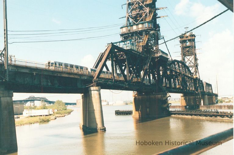 Digital image of color photo of a PATH train crossing the Hackensack River bridge, August, 1998. picture number 1