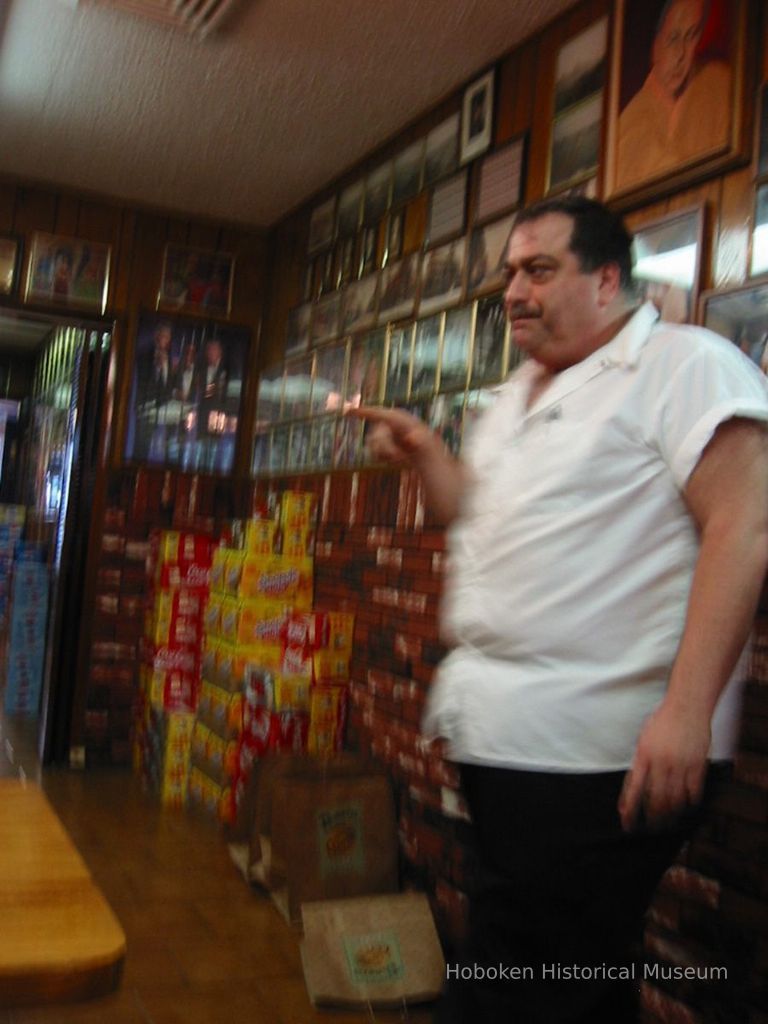 Digital copy of color photo of a cook or an owner of Piccolo's Clam Bar talking to food tour members there, 92 Clinton St., Hoboken, Oct. 18, 2003. picture number 1