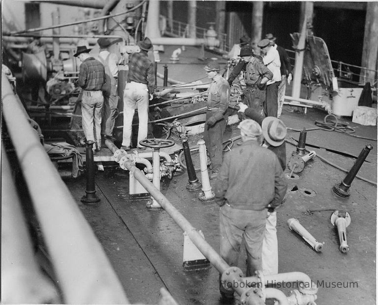 B+W photo showing workers repairing damage on the main deck on unidentified vessel at Bethlehem Steel Shipyard, Hoboken Division, no date, ca. 1940. picture number 1