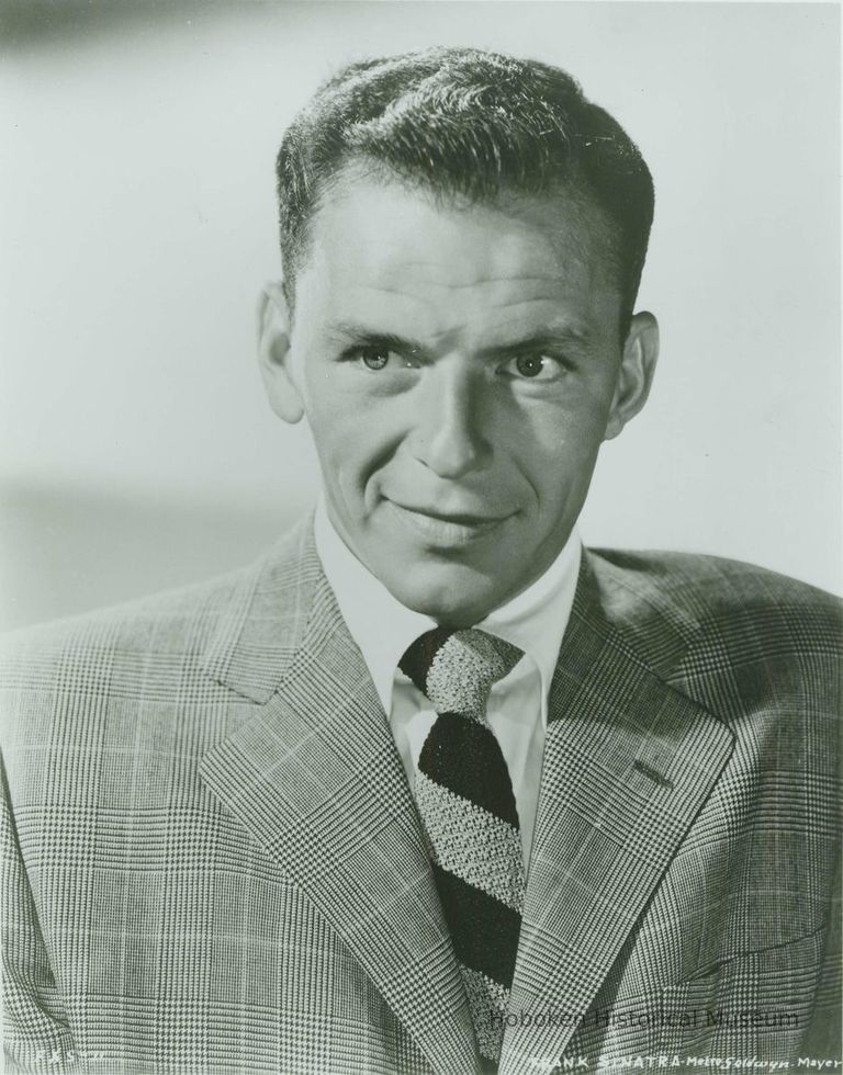 Black-and-white photo of Frank Sinatra in a check jacket and striped tie, no place, no date, ca. 1950. picture number 1