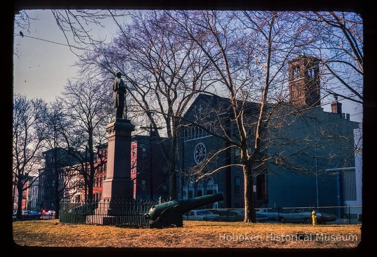 Color slide of eye-level view of the Civil War Monument on the west side of Stevens Park with Saints Peter & Paul Catholic church across the street picture number 1