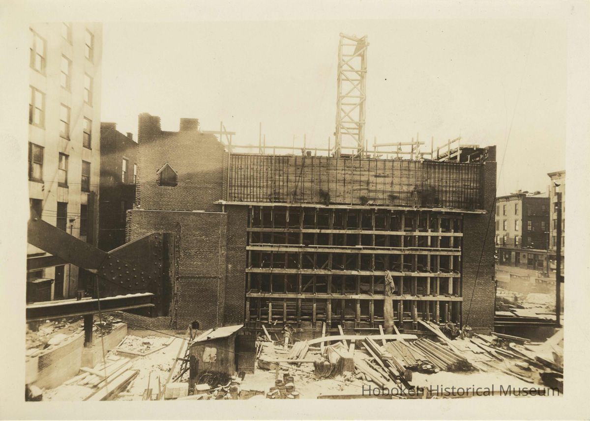 Sepia-tone photo of steel frame erection & construction of the stage house for the Fabian Theatre, Hoboken, no date, ca. Feb.-March, 1928. picture number 1
