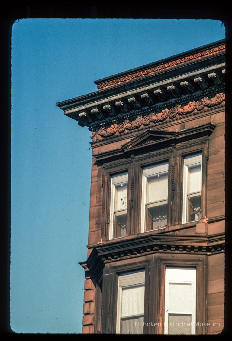 Color slide of close-up view of cornice, brackets, frieze, pediment window head and bay window at an unidentified location picture number 1