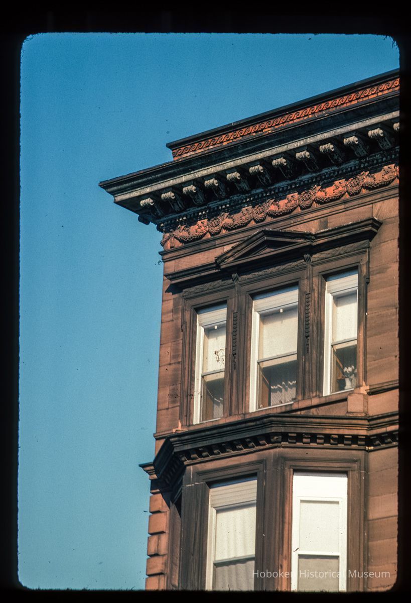 Color slide of close-up view of cornice, brackets, frieze, pediment window head and bay window at an unidentified location picture number 1